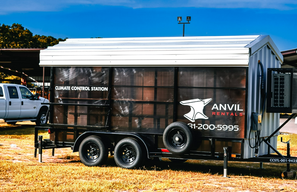 Side profile of a 16 foot Anvil Rentals climate control station trailer with the company logo and phone number on the wall