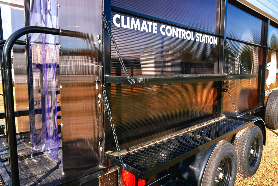 Close view of the Climate Control Station lettering and fold-down exterior shelf on the side of an Anvil Rentals trailer