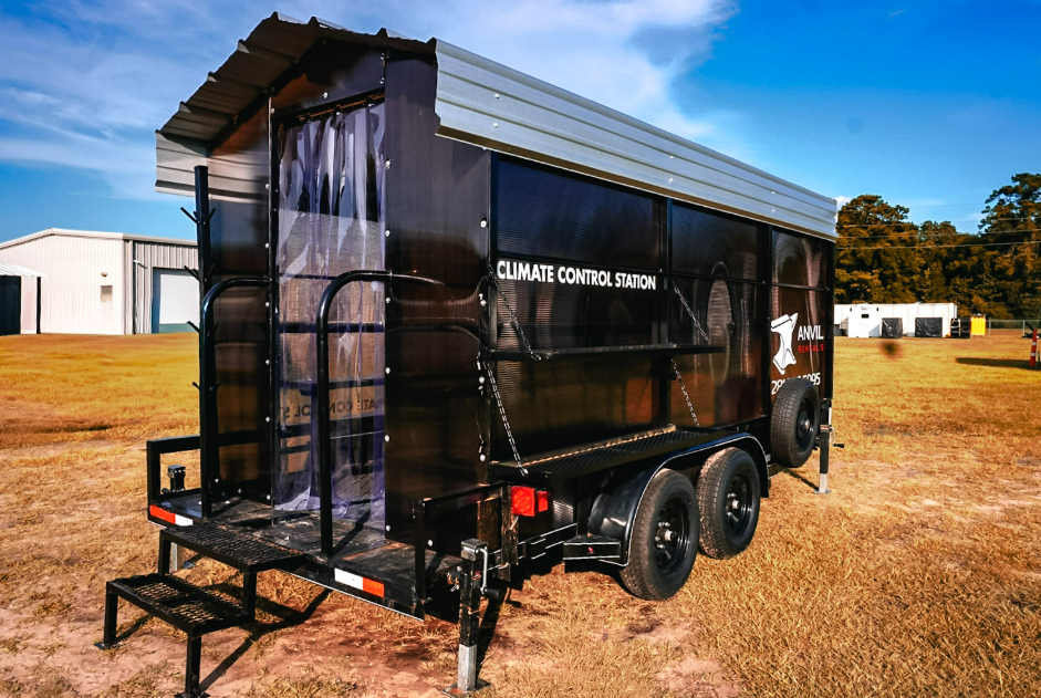 Full exterior view of an Anvil Rentals climate control station trailer with entry steps, strip curtain, and hard hat tree