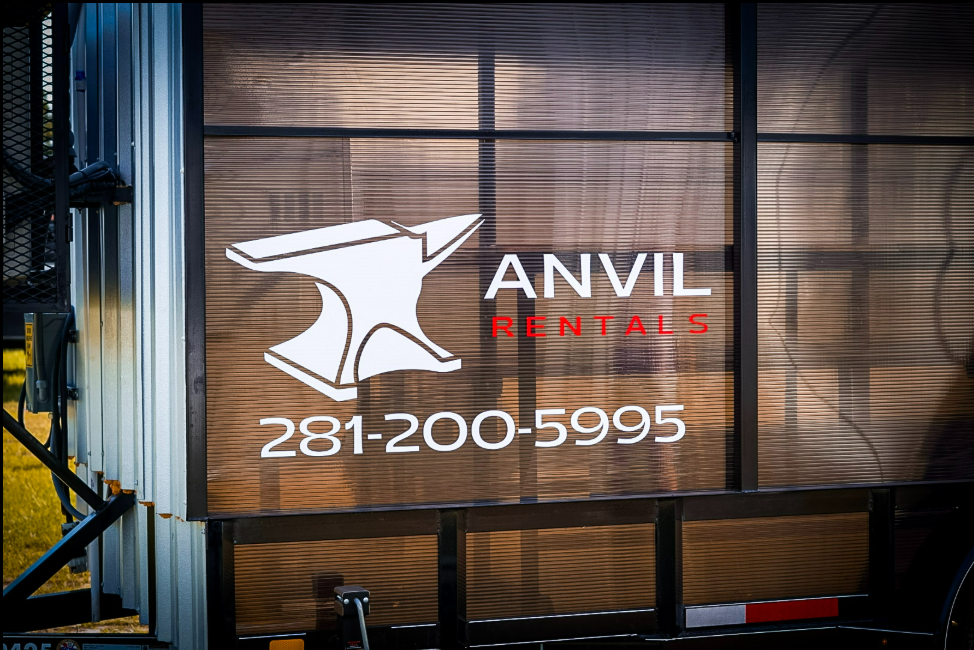Anvil Rentals logo and the phone number 281-200-5995 applied to the side panel of a rental unit